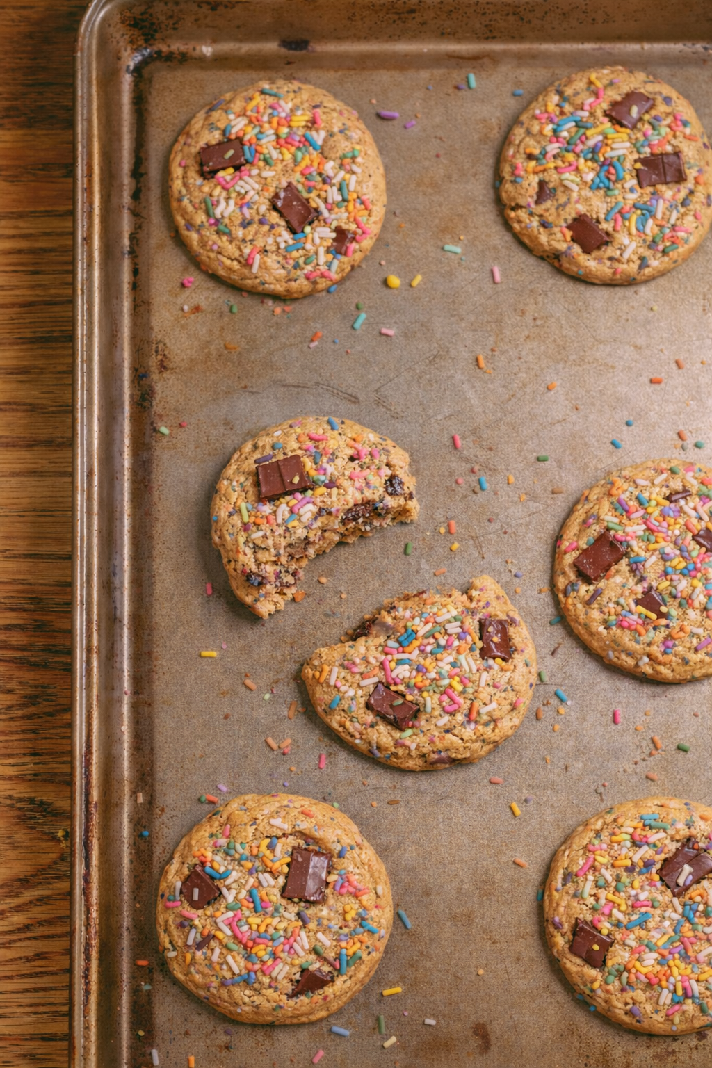Cookies with sprinkles and chocolate chips on a baking tray
