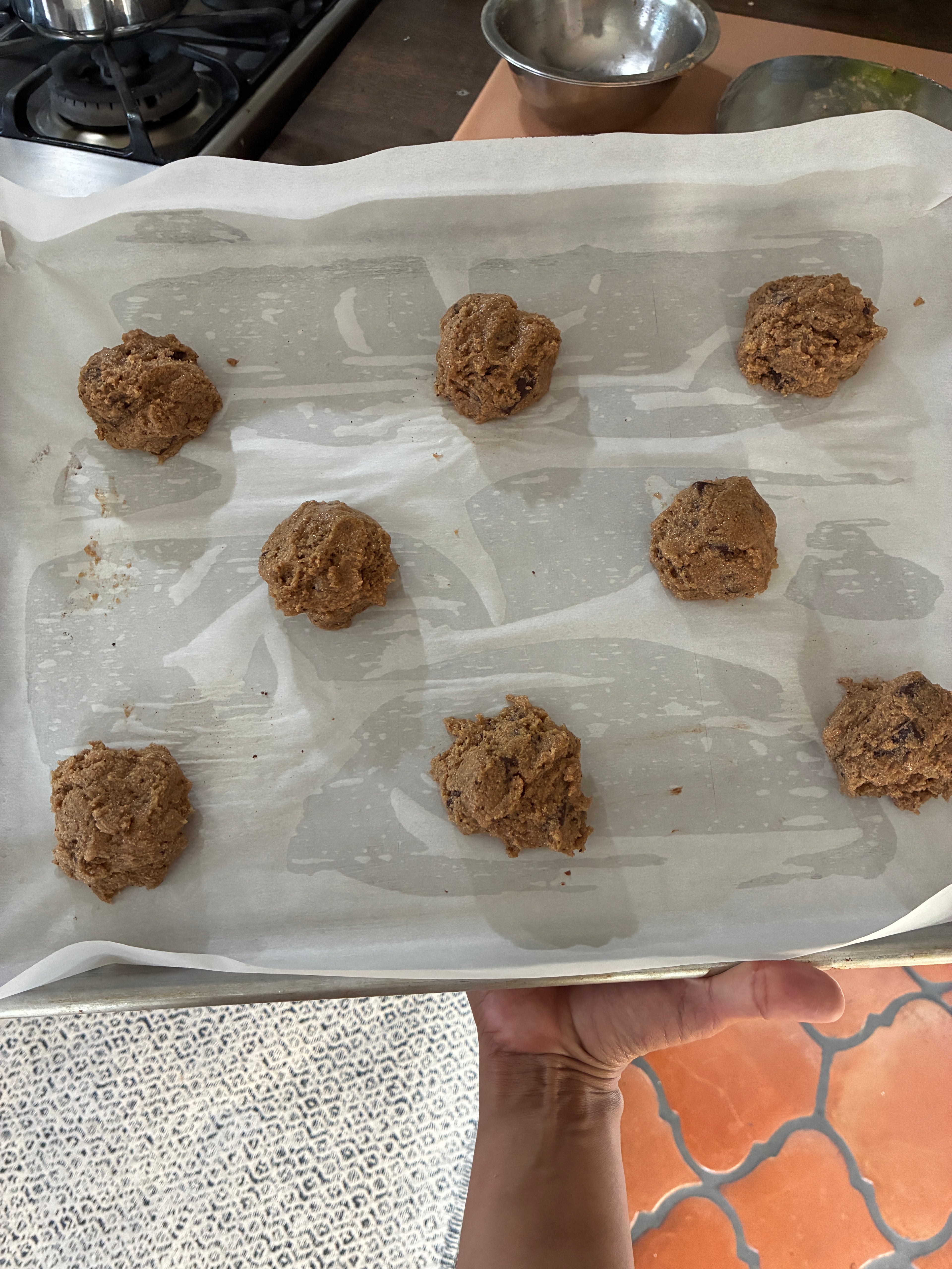 A picture of the cookie dough balls on a baking sheet.
