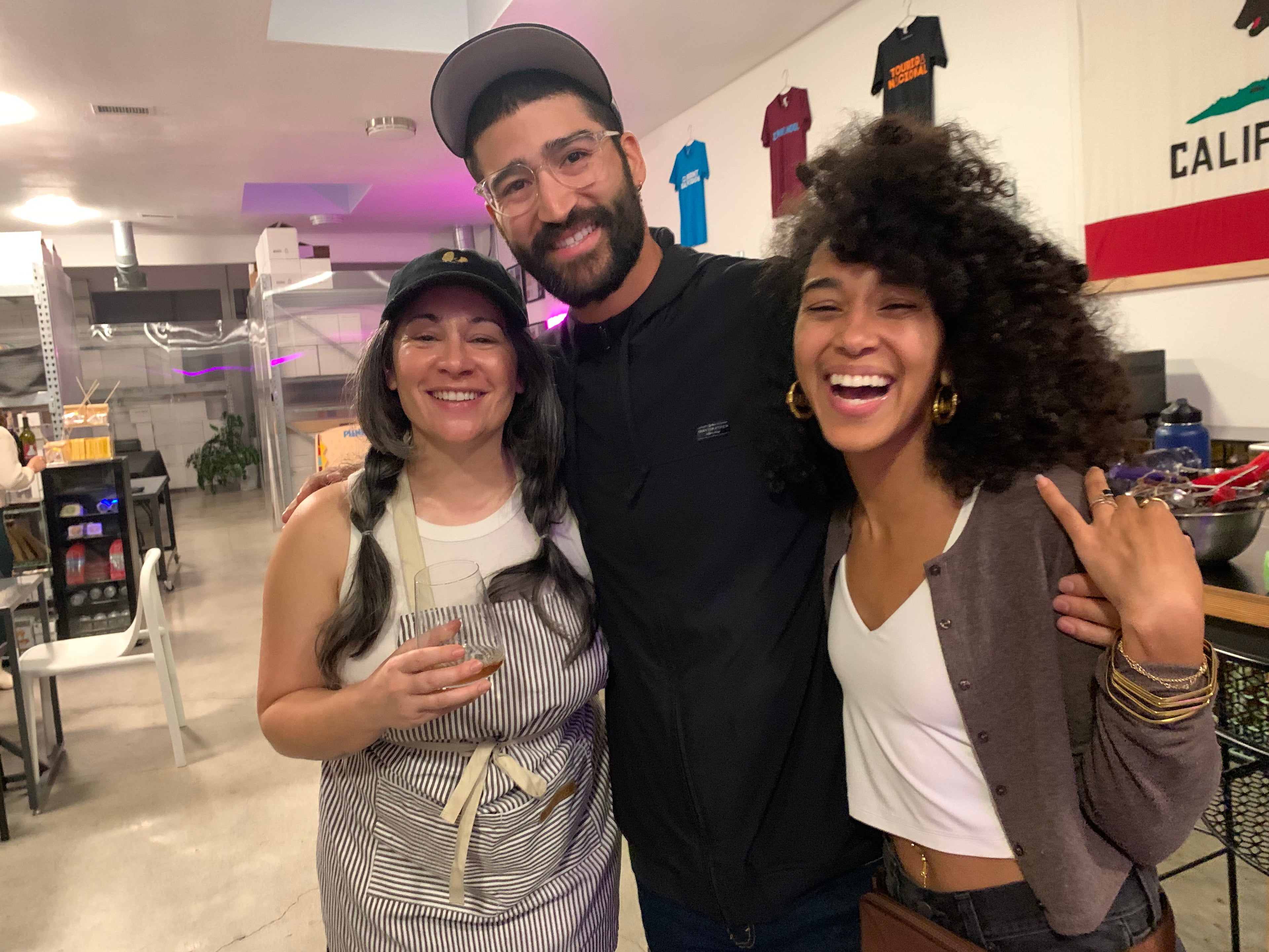 Three people posing together in a casual indoor setting