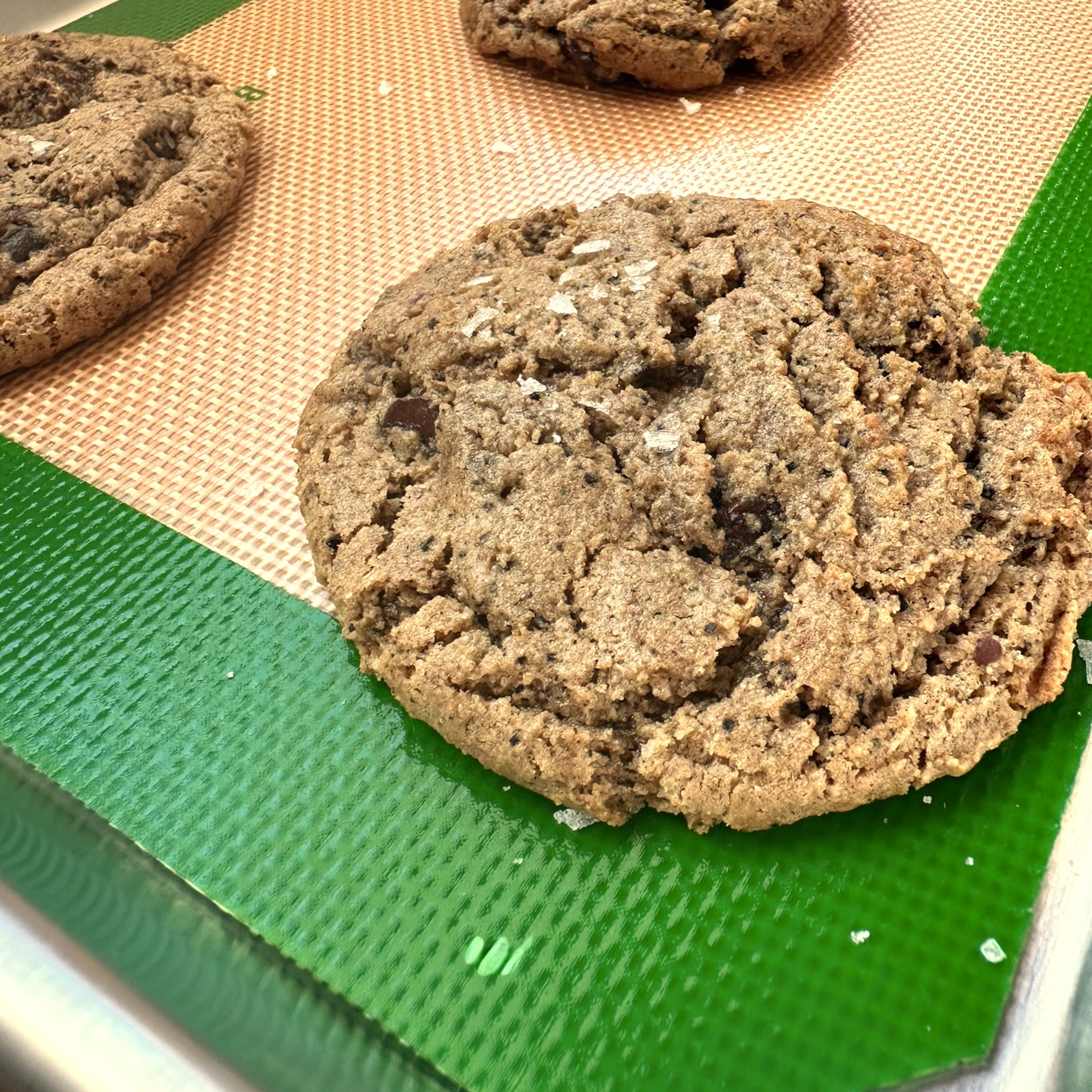 Cookies on a baking mat with a green border